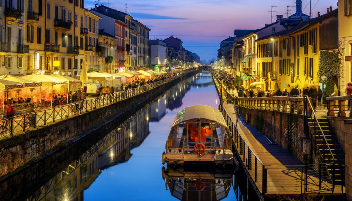 A lone barge sits in the water of th Naviglo Grande canal, Italy.