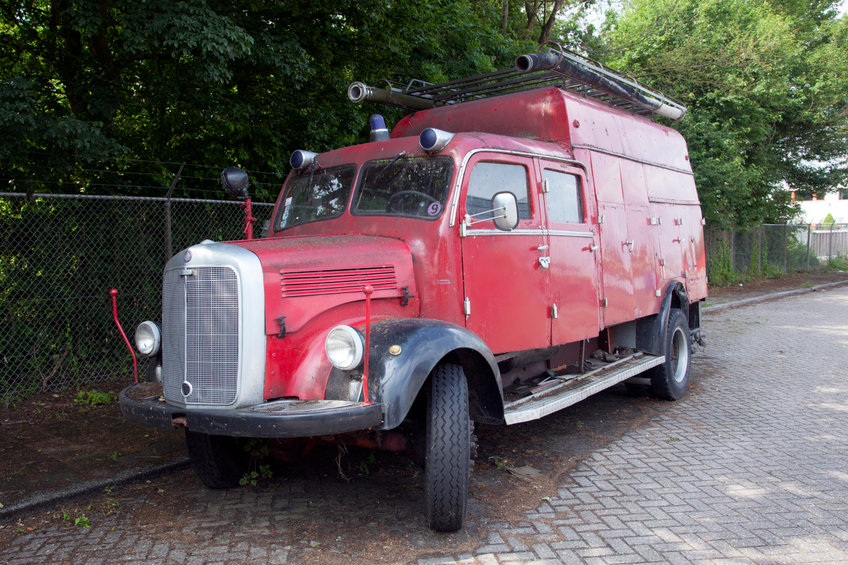 Old red fire truck parked in the Netherlands