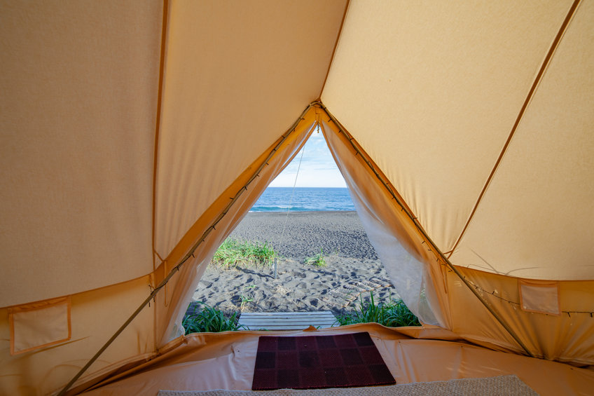 Looking out of the front of a bell tent towards the ocean