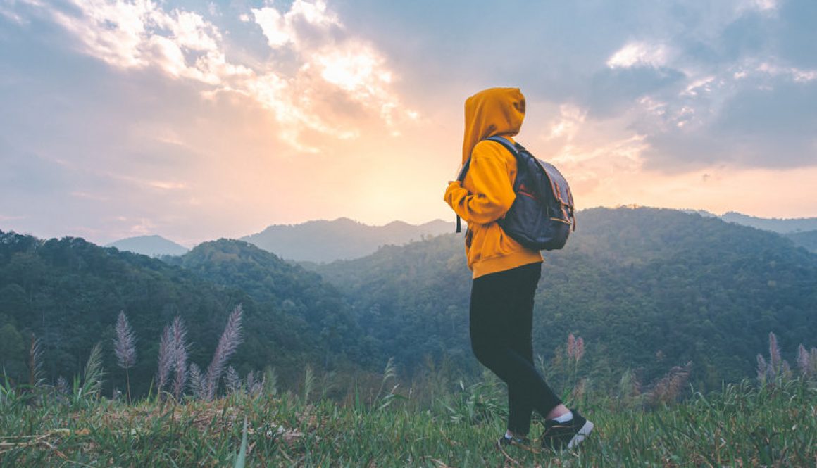 Woman hiking with backpack.